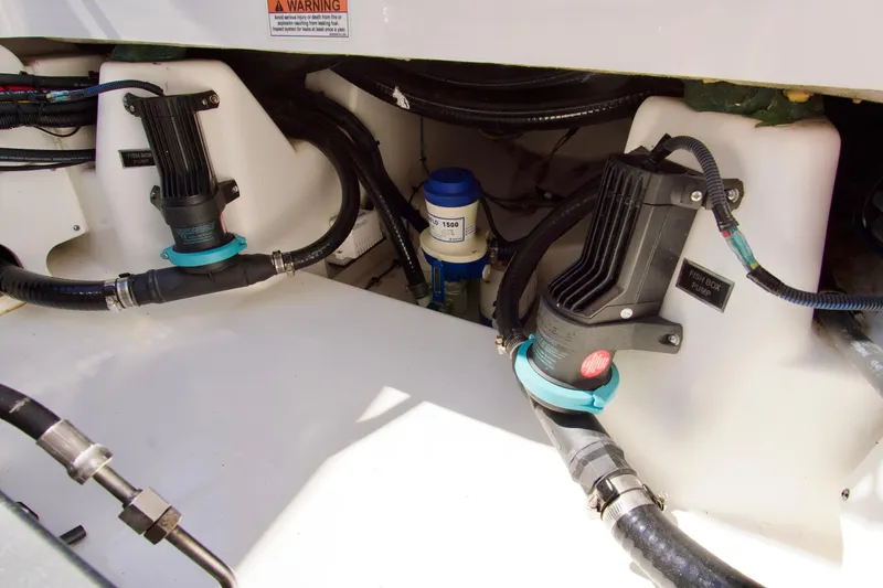 Slide: The Image of 2023 Blackfin 302 CC boat's engine compartment with pumps and wiring. - 37