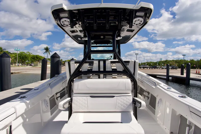 Slide: The Image of 2023 Blackfin 302 CC boat interior at dock, showcasing sleek seating and modern design. - 38