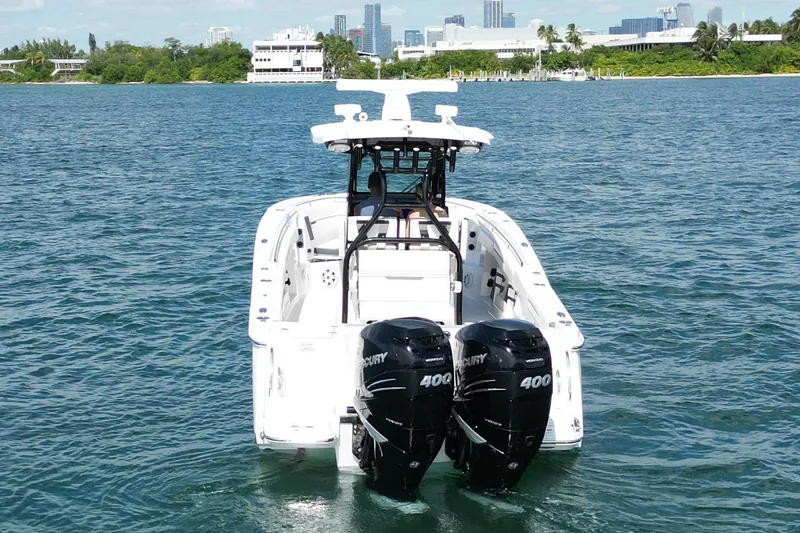 Slide: The Image of 2023 Blackfin 302 CC boat with dual Mercury 400 engines on open water. - 4