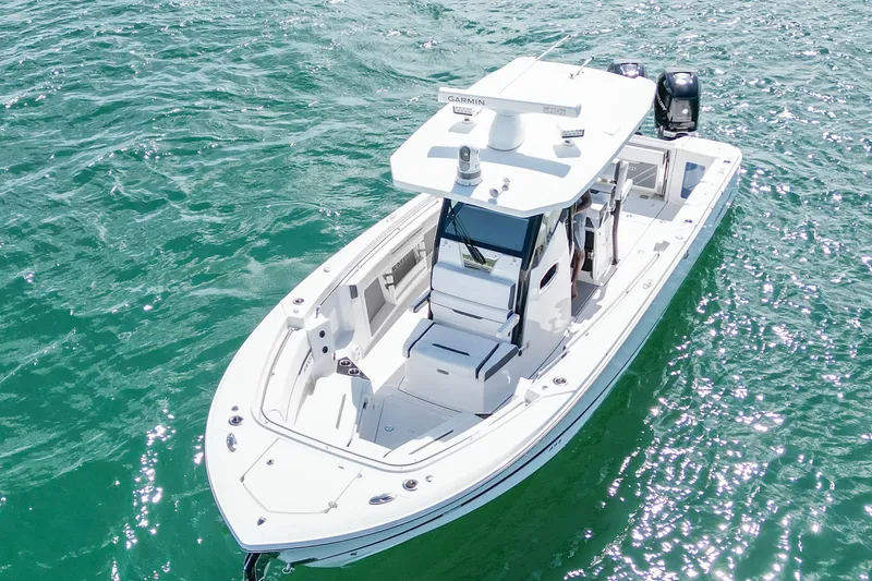 Slide: The Image of 2023 Blackfin 302 CC boat on clear blue water, aerial view. - 5