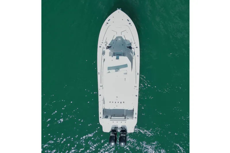 Slide: The Image of Aerial view of 2023 Blackfin 302 CC boat on clear green water. - 6