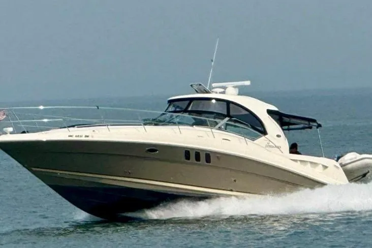 The Image of 2006 Sea Ray Sundancer 400 cruising on open water, showcasing sleek design and performance. - 0