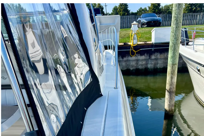 Slide: The Image of 2006 Sea Ray Sundancer 400 docked, reflecting water and nearby boat in marina. - 11