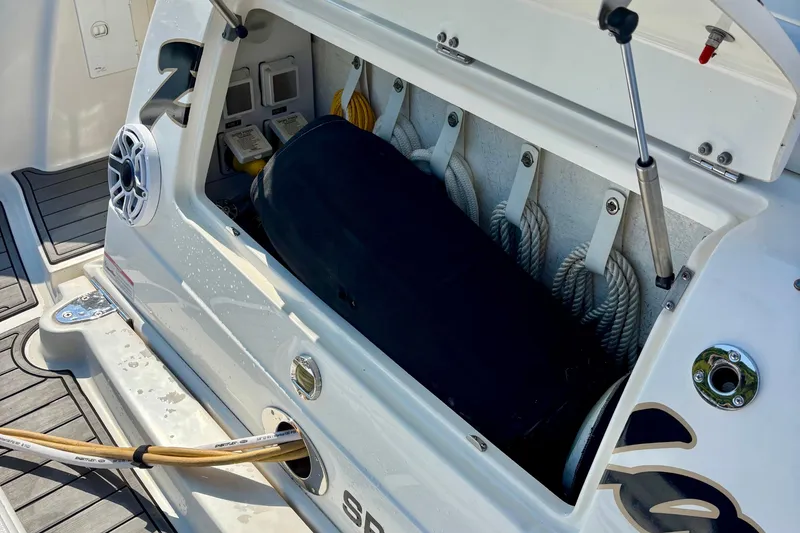 Slide: The Image of Storage compartment of a 2006 Sea Ray Sundancer 400 boat, featuring ropes and equipment. - 12