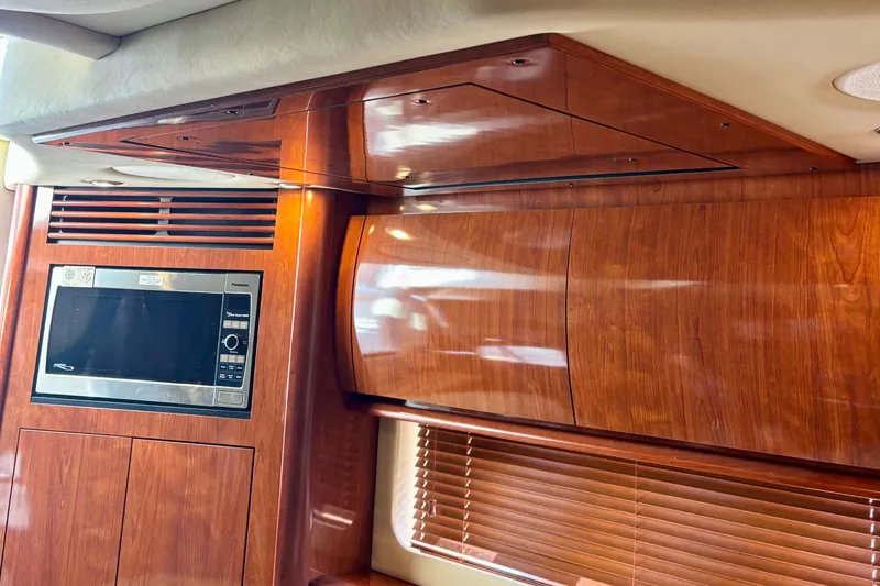Slide: The Image of Interior of 2006 Sea Ray Sundancer 400 yacht with wooden cabinetry and built-in microwave. - 15