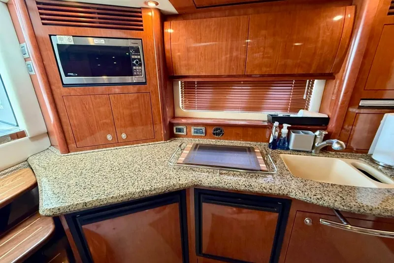 Slide: The Image of Luxurious kitchen area in a 2006 Sea Ray Sundancer 400 yacht with wood cabinetry. - 16