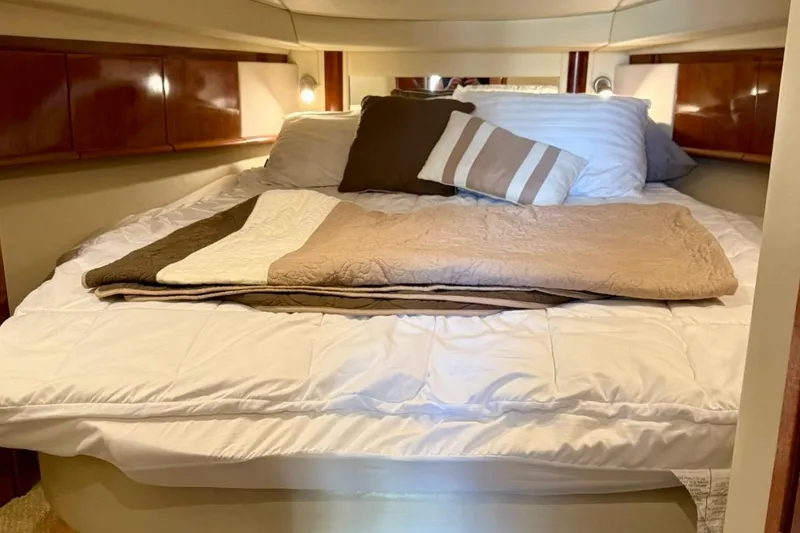 Slide: The Image of Luxurious cabin bedroom in a 2006 Sea Ray Sundancer 400 yacht with cozy bedding. - 19