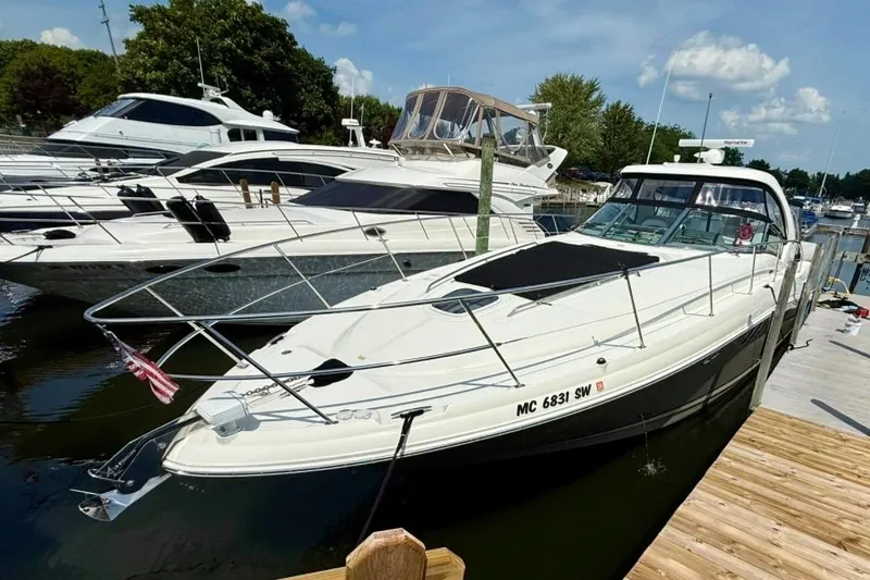 Slide: The Image of 2006 Sea Ray Sundancer 400 yacht docked at marina, surrounded by other boats. - 2
