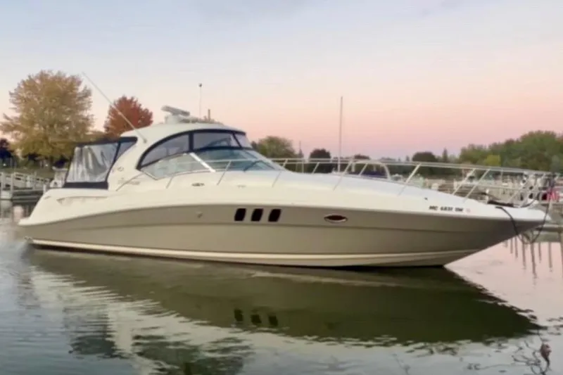 Slide: The Image of 2006 Sea Ray Sundancer 400 yacht docked at sunset with autumn trees in background. - 3