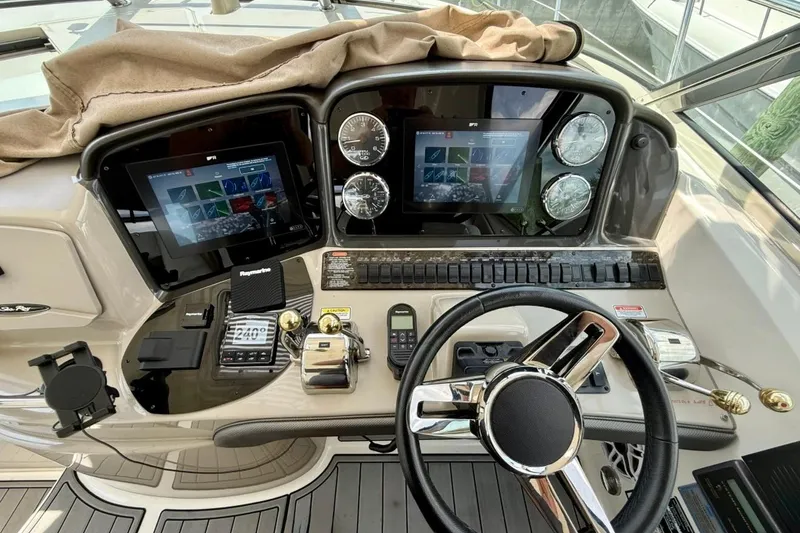 Slide: The Image of Helm of 2006 Sea Ray Sundancer 400 with modern navigation equipment and controls. - 5