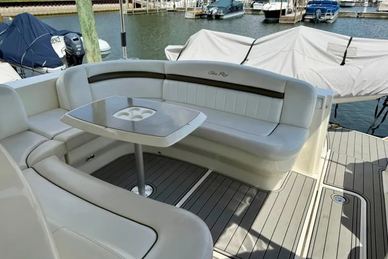 Slide: The Image of Luxury seating area on a 2006 Sea Ray Sundancer 400 yacht, docked at a marina. - 7