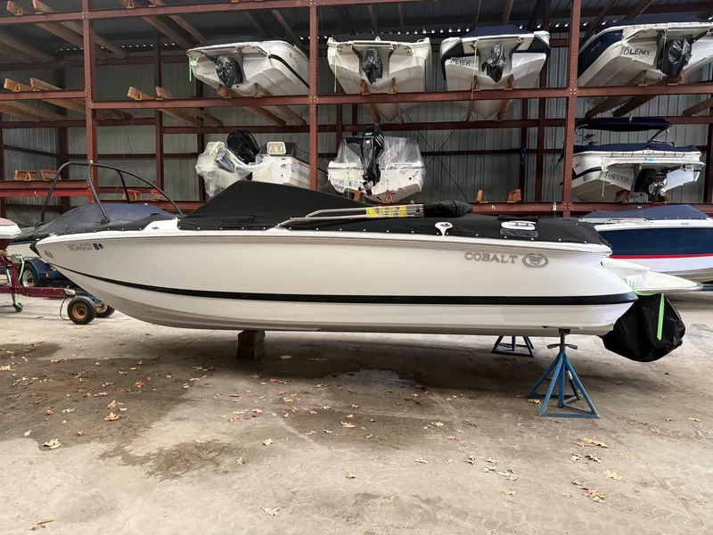 The Image of 2009 Cobalt 230BR boat stored on stands in warehouse. - 1