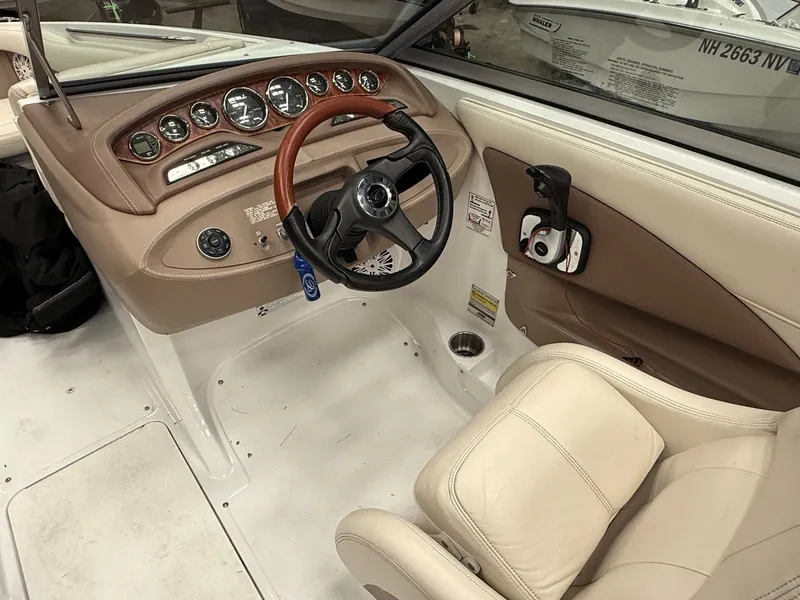 Slide: The Image of Interior of a 2009 Cobalt 230BR boat with steering wheel and dashboard. - 3