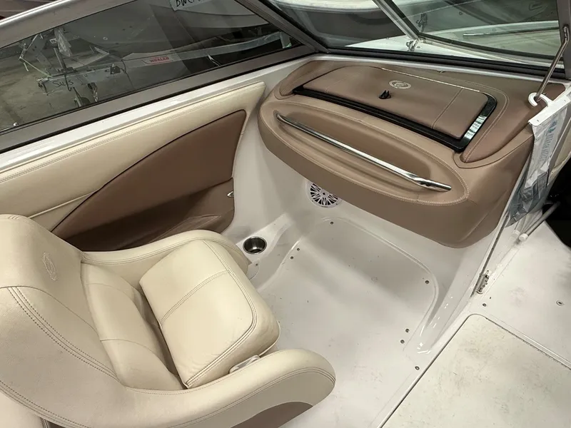 Slide: The Image of Interior of a 2009 Cobalt 230BR boat with beige leather seats. - 7