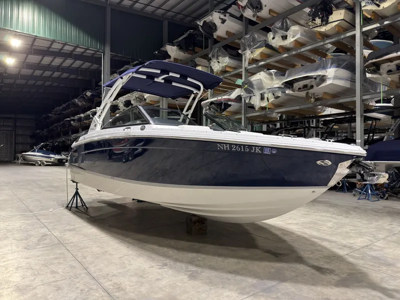 The Image of 2022 Cobalt R6 boat in warehouse, blue and white design. - 1