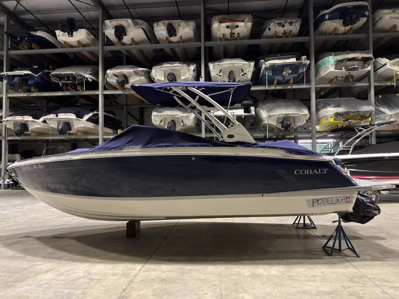 Slide: The Image of 2022 Cobalt R6 boat in storage facility, side view. - 11