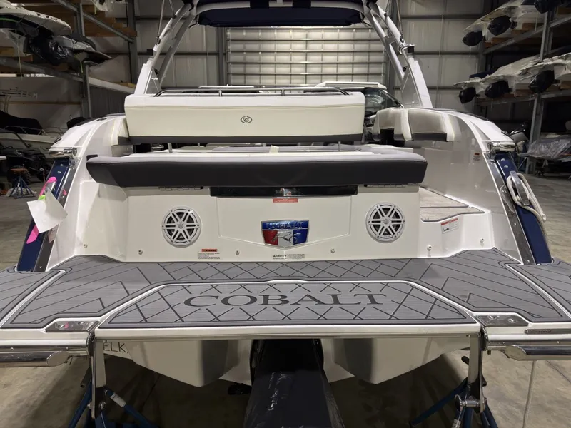 Slide: The Image of Rear view of a 2022 Cobalt R6 boat in a warehouse. - 20