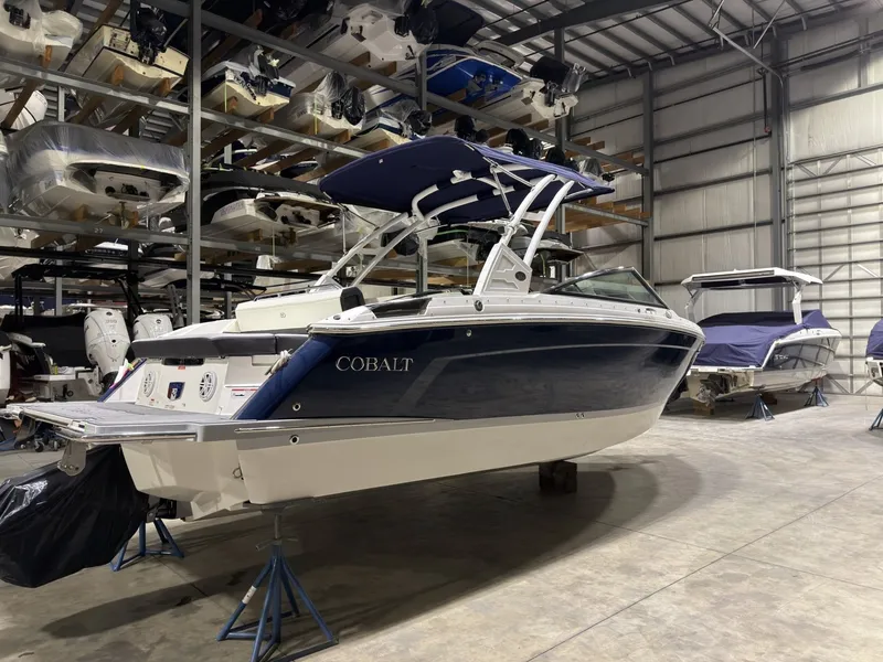 Slide: The Image of 2022 Cobalt R6 boat in storage facility, blue and white design. - 4