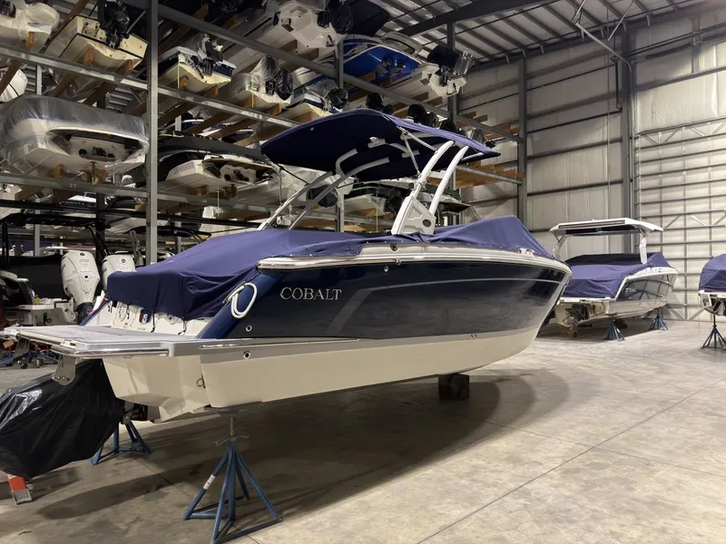 Slide: The Image of 2022 Cobalt R6 boat in storage facility, blue cover design. - 9