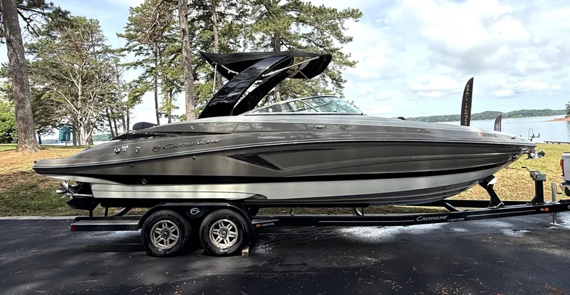Slide: The Image of 2020 Crownline 290 SS boat on trailer, parked outdoors. - 3