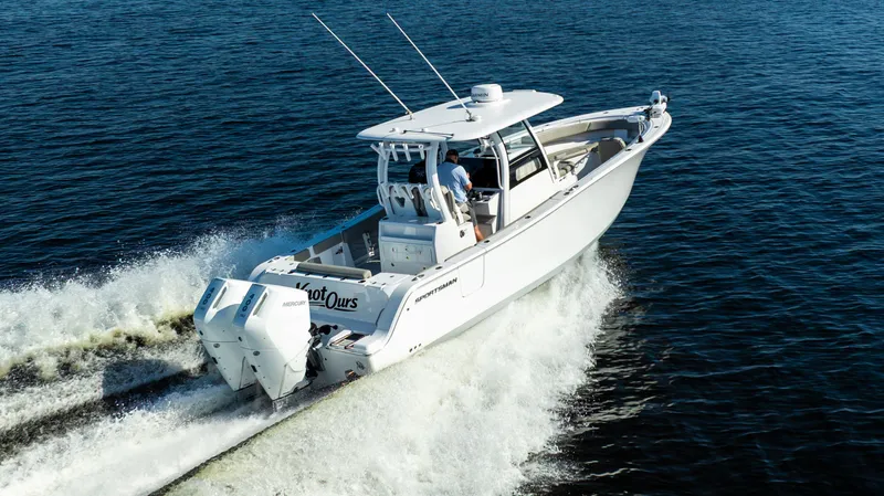 Slide: The Image of 2024 Sportsman Open 322 Center Console cruising on water. - 12