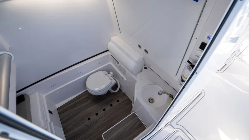Slide: The Image of Interior of 2024 Sportsman Open 322 Center Console with toilet and sink. - 42