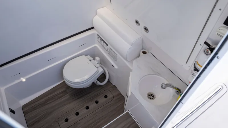 Slide: The Image of Interior of 2024 Sportsman Open 322 Center Console with toilet and sink. - 43