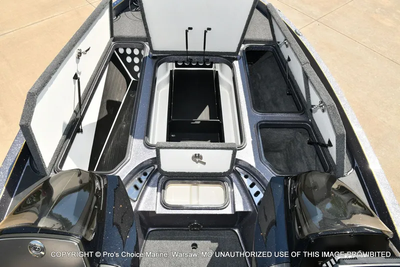 Slide: The Image of Interior view of a 2013 Ranger Z520c Dual Console boat with open storage compartments. - 9