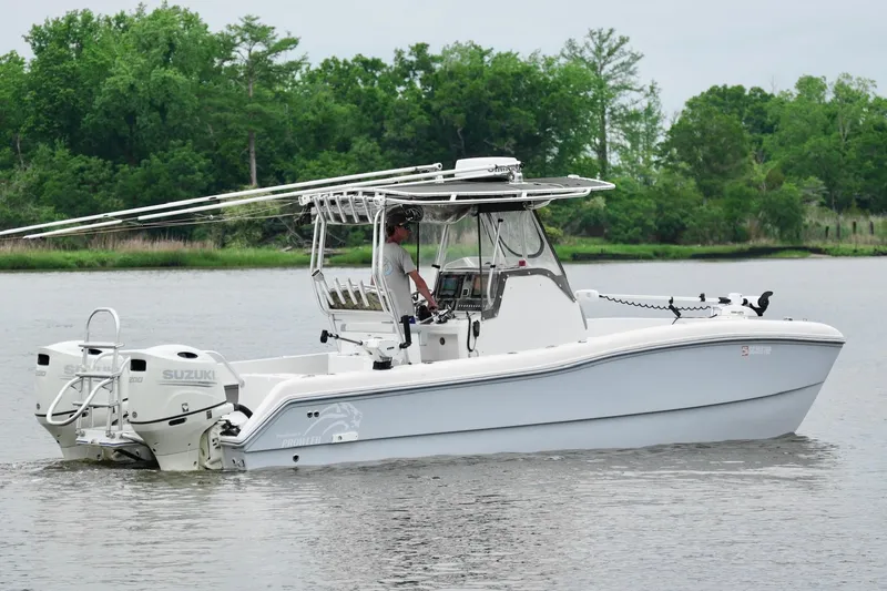 Slide: The Image of 2013 Prowler 25 boat with Suzuki engine cruising on a calm river. - 10