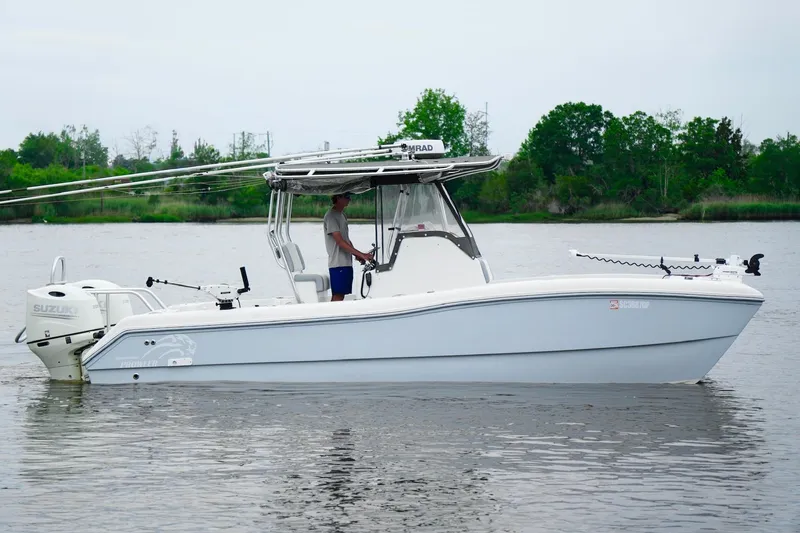 Slide: The Image of 2013 Prowler 25 boat with Suzuki engine on calm water, side view. - 11