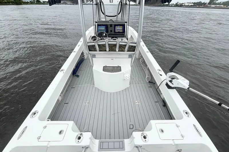 Slide: The Image of 2013 Prowler 25 boat interior with modern controls on open water. - 14
