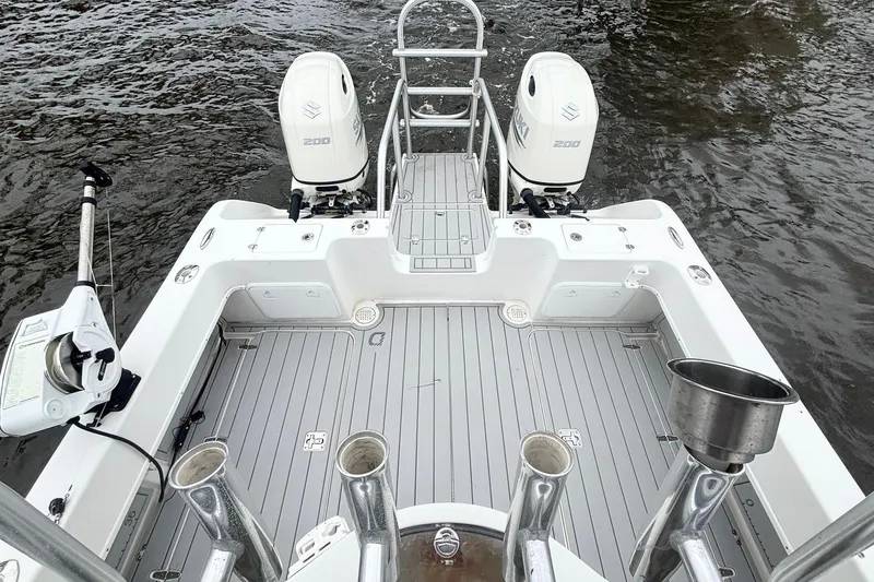 Slide: The Image of 2013 Prowler 25 boat with dual Suzuki 200 engines on water. - 18