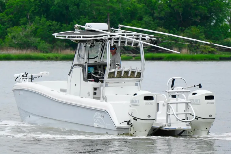 Slide: The Image of 2013 Prowler 25 boat with dual Suzuki engines on a calm river. - 3