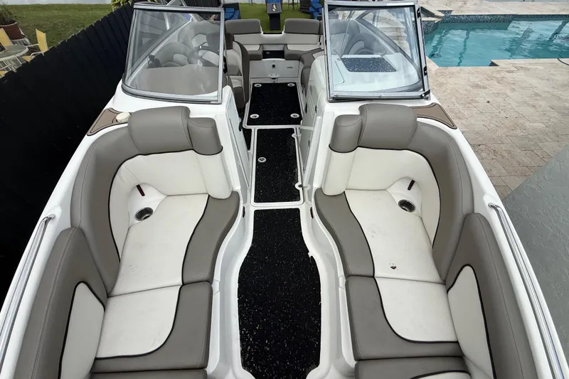 Slide: The Image of 2012 Yamaha Boats 242 Limited S interior with spacious seating and sleek design by a poolside. - 22