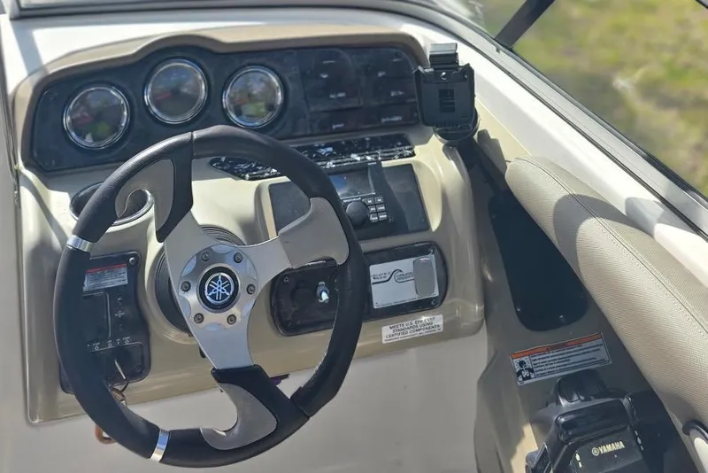 Slide: The Image of 2012 Yamaha Boats 242 Limited S dashboard with steering wheel and control panel. - 12