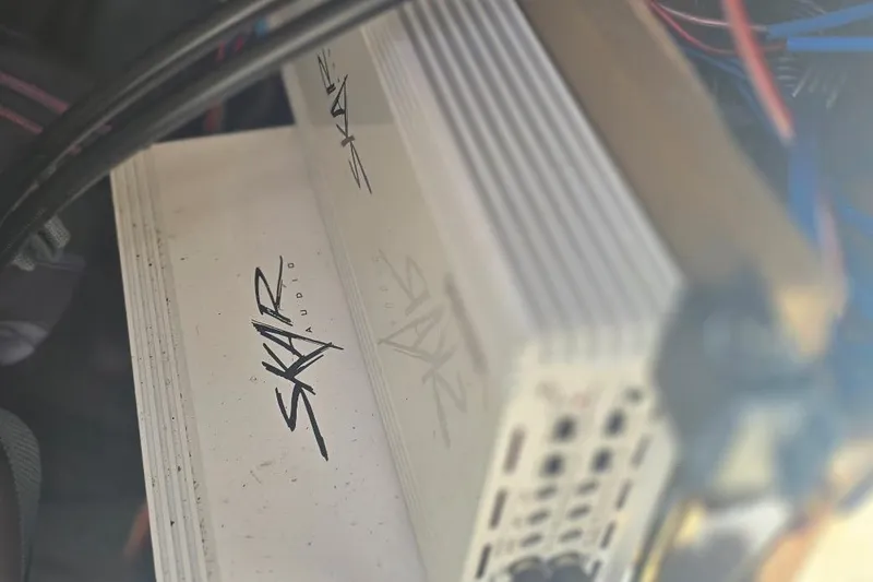 Slide: The Image of Skar Audio amplifier in a 2012 Yamaha Boats 242 Limited S, surrounded by wiring. - 13
