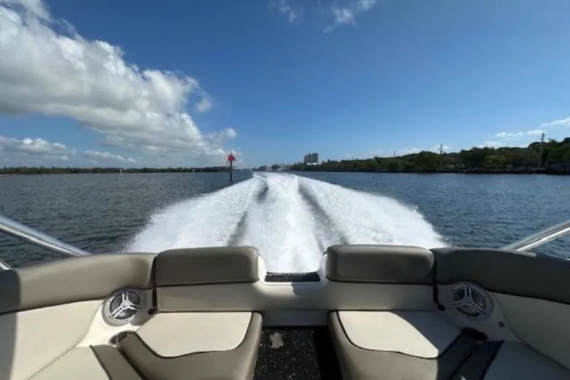 Slide: The Image of 2012 Yamaha Boats 242 Limited S cruising on a sunny day, leaving a wake trail. - 18