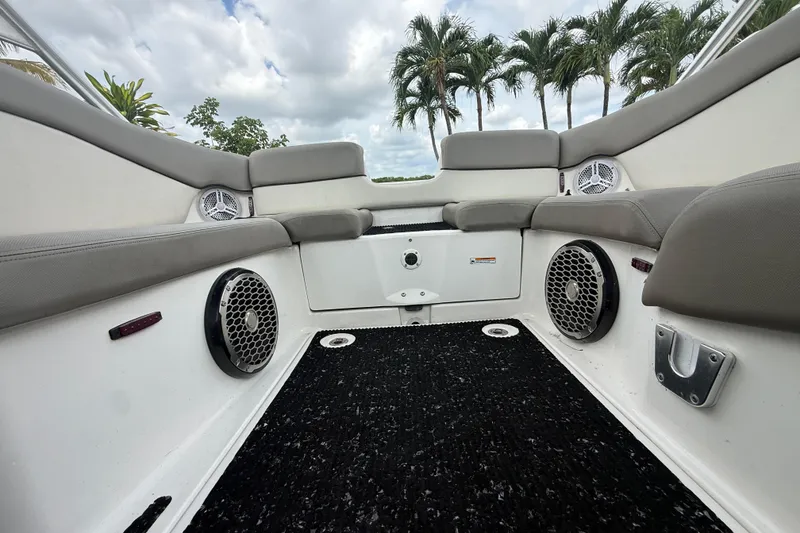 Slide: The Image of Interior view of 2012 Yamaha Boats 242 Limited S, featuring cushioned seating and speakers. - 19