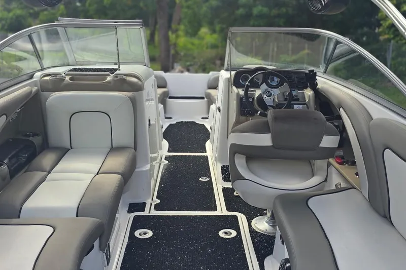 Slide: The Image of Interior of 2012 Yamaha Boats 242 Limited S, featuring plush seating and modern dashboard. - 7