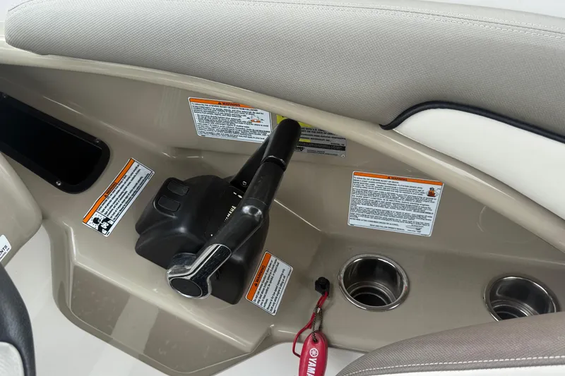 Slide: The Image of Control panel of 2012 Yamaha Boats 242 Limited S with throttle and warning labels. - 15