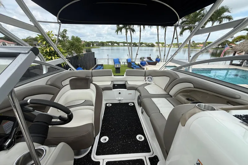 Slide: The Image of 2012 Yamaha Boats 242 Limited S interior with lake view and palm trees. - 17