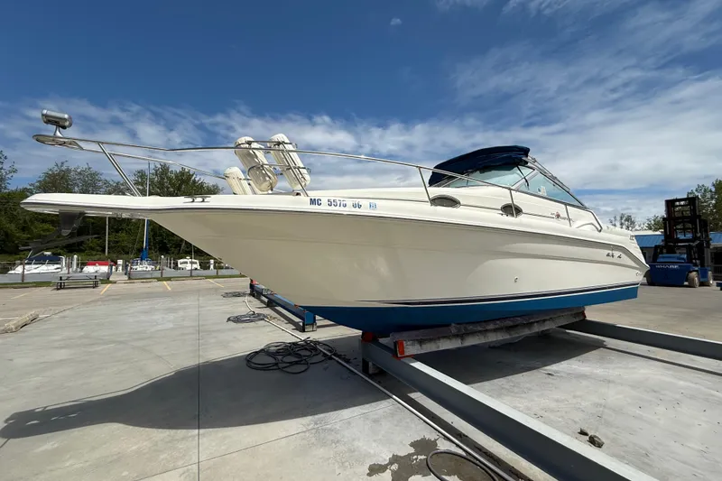 The Image of 1997 Sea Ray 270 Sundancer boat on trailer under clear blue sky. - 0