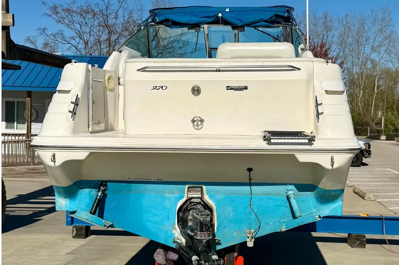 Slide: The Image of 1997 Sea Ray 270 Sundancer boat on trailer, rear view, with blue accents. - 14