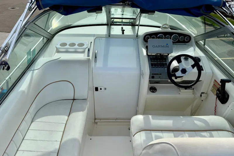 Slide: The Image of 1997 Sea Ray 270 Sundancer cockpit with Garmin navigation and white seating. - 15