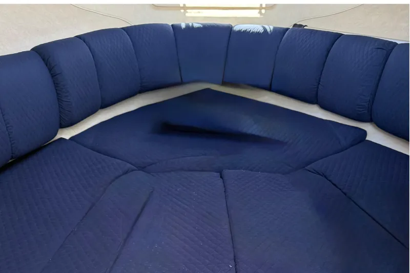 Slide: The Image of Interior seating of 1997 Sea Ray 270 Sundancer with blue cushions. - 18