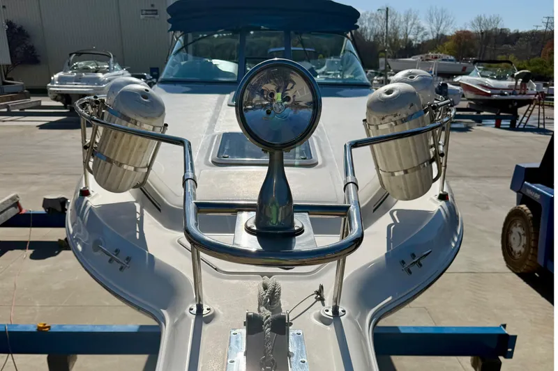 Slide: The Image of 1997 Sea Ray 270 Sundancer boat bow with fenders and spotlight in marina. - 4