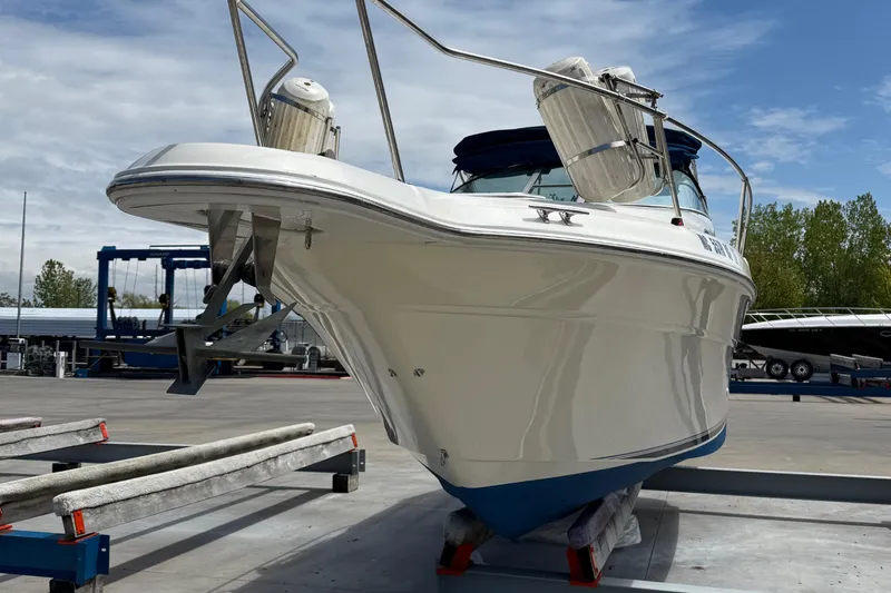 Slide: The Image of 1997 Sea Ray 270 Sundancer boat on dry dock, showcasing sleek design and sturdy build. - 5