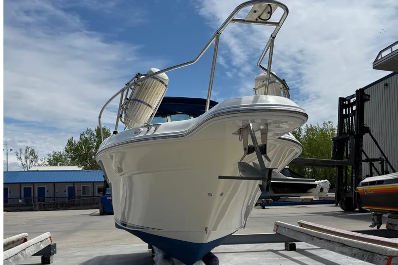 Slide: The Image of 1997 Sea Ray 270 Sundancer boat on trailer, ready for launch under a clear sky. - 6