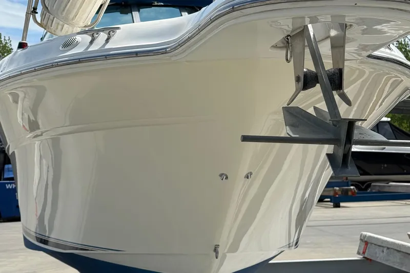 Slide: The Image of 1997 Sea Ray 270 Sundancer boat with anchor, docked on a sunny day. - 7