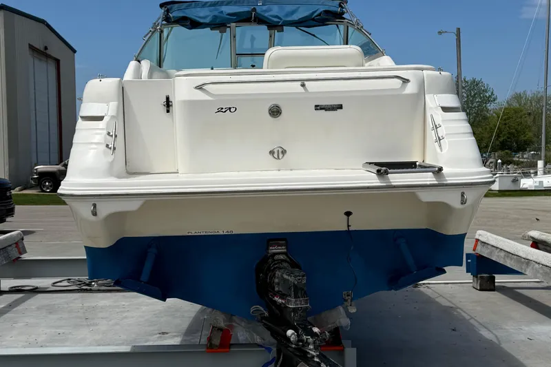 Slide: The Image of 1997 Sea Ray 270 Sundancer boat on trailer, rear view, with blue hull and white deck. - 8